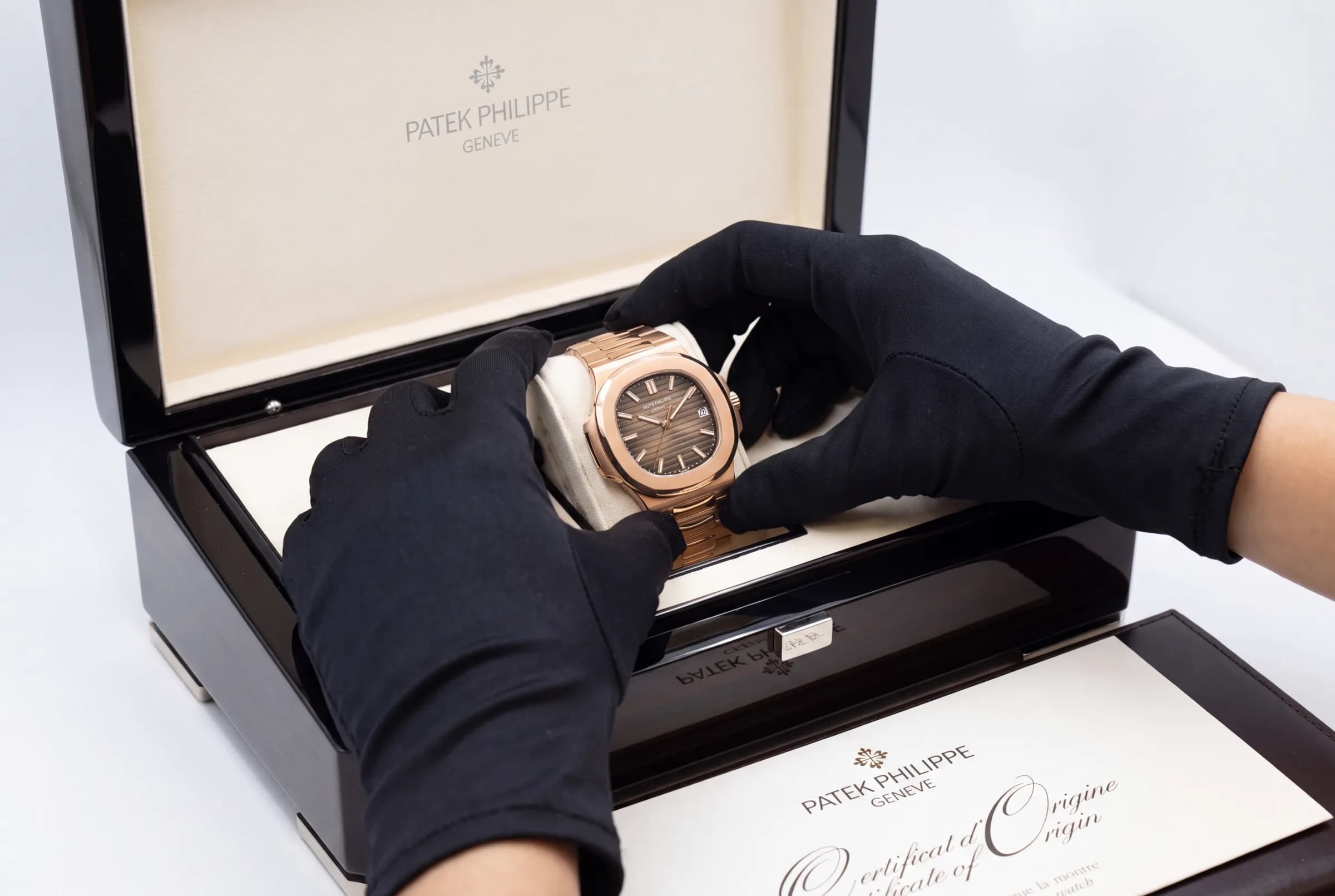 Gloved handling of a boxed watch
